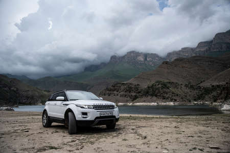 Range Rover Evoque car on the background of the mountains of the North Caucasus in Russia. Cloudy day on June 7, 2022のeditorial素材