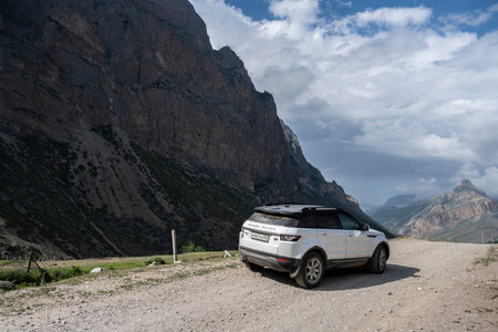 Range Rover Evoque car on the background of the mountains of the North Caucasus in Russia. Sunny day on June 6, 2022のeditorial素材