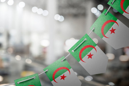 A garland of Algeria national flags on an abstract blurred backgroundの写真素材