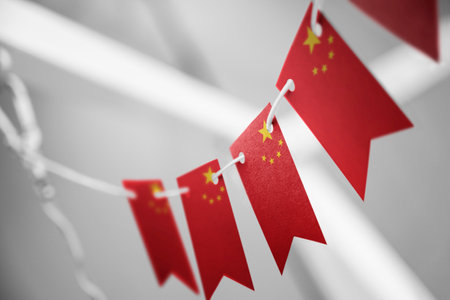 A garland of China national flags on an abstract blurred backgroundの写真素材