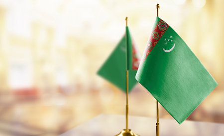 Small flags of the Turkmenistan on an abstract blurry background.の写真素材