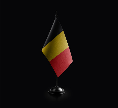 Small national flag of Belgium on a black background.の写真素材