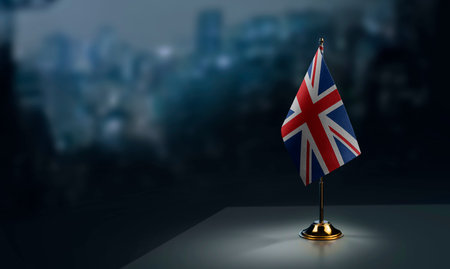 Small flags of the United Kingdom on an abstract blurry background.の写真素材