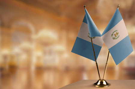 Small flags of the Guatemala on an abstract blurry background.の写真素材