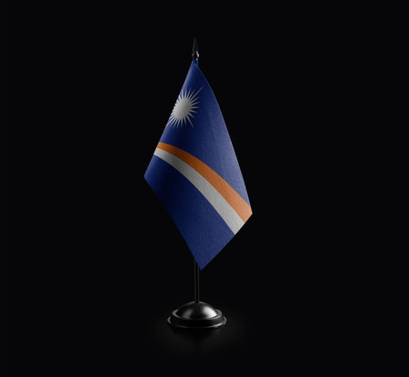 Small national flag of the Marshall on a black background.の写真素材