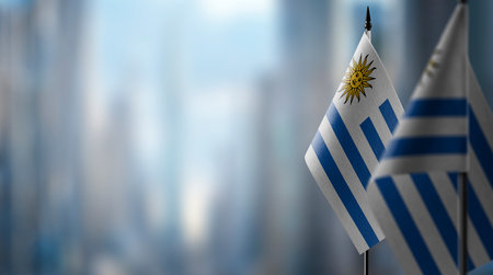 Small flags of the Uruguay on an abstract blurry background.の写真素材