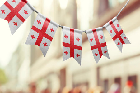A garland of Georgia national flags on an abstract blurred background.の写真素材