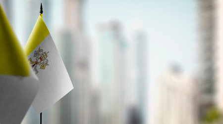 Small flags of the Vatican on an abstract blurry background.の写真素材