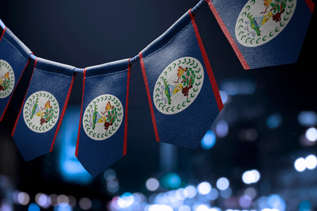 A garland of Belize national flags on an abstract blurred background.の写真素材