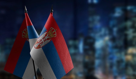Small flags of the Serbia on an abstract blurry background.の写真素材
