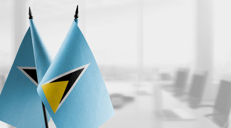 Small flags of the Saint Lucia on an abstract blurry background.の写真素材