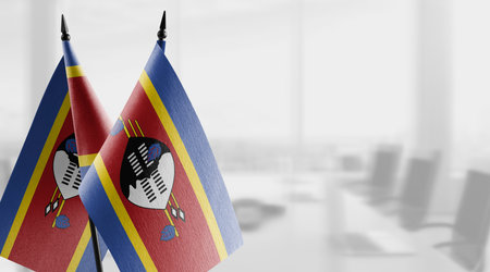 Small flags of the Swaziland on an abstract blurry background.の写真素材
