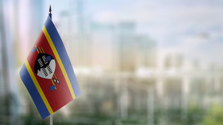 Small flags of the Swaziland on an abstract blurry background.の写真素材