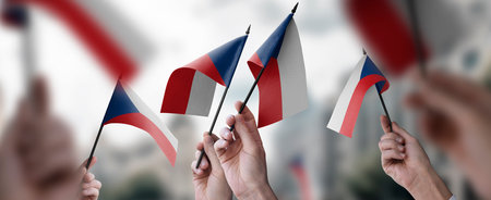 A group of people holding small flags of the Czechia in their hands.の写真素材