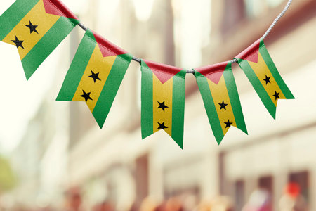 A garland of Sao Tome and Principe national flags on an abstract blurred background.の写真素材