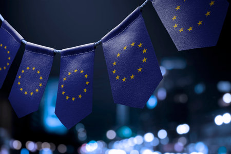 A garland of European Union national flags on an abstract blurred background.の写真素材
