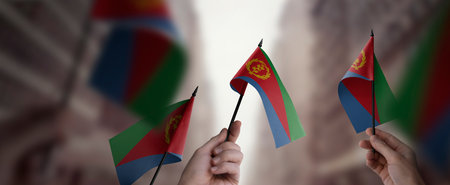 A group of people holding small flags of the Eritrea in their hands.の写真素材