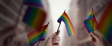 A group of people holding small flags of the LGBT in their hands.の写真素材