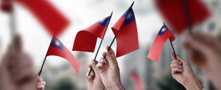 A group of people holding small flags of the Taiwan in their hands.の写真素材