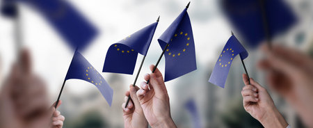 A group of people holding small flags of the European Union in their hands.の写真素材