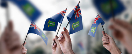 A group of people holding small flags of the British Virgin Islands in their hands.の写真素材