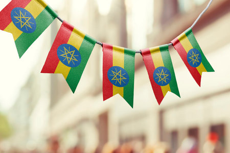 A garland of Ethiopia national flags on an abstract blurred background.の写真素材