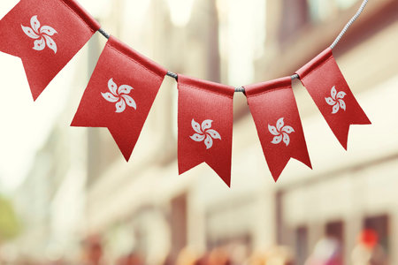 A garland of Hong Kong national flags on an abstract blurred background.の写真素材