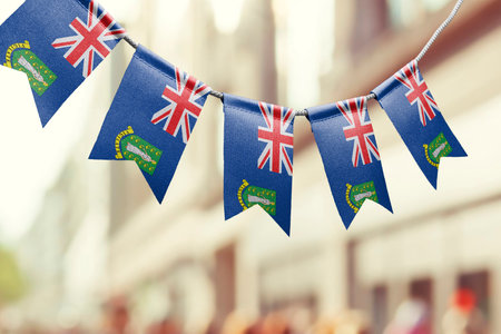 A garland of British Virgin Islands national flags on an abstract blurred background.の写真素材