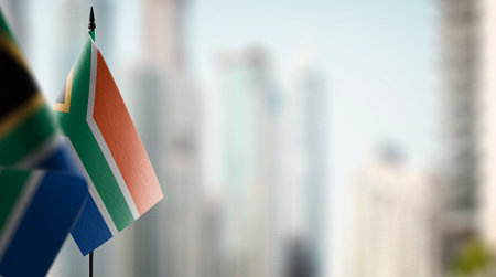 Small flags of the South Africa on an abstract blurry background.の写真素材