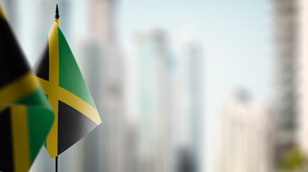 Small flags of the Jamaica on an abstract blurry background.の写真素材
