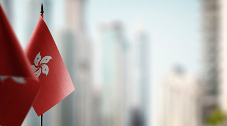 Small flags of the Hong Kong on an abstract blurry background.の写真素材