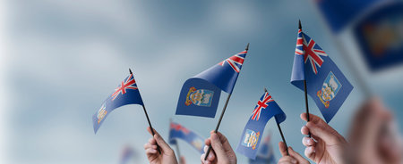 A group of people holding small flags of the Falkland Islands in their hands.の写真素材