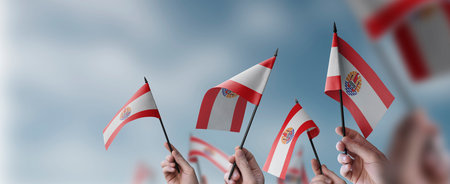 A group of people holding small flags of the French Polynesia in their hands.の写真素材