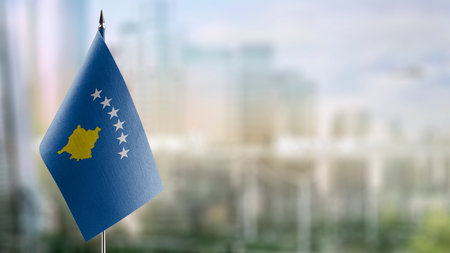 A small Kosovo flag on an abstract blurry background.の写真素材