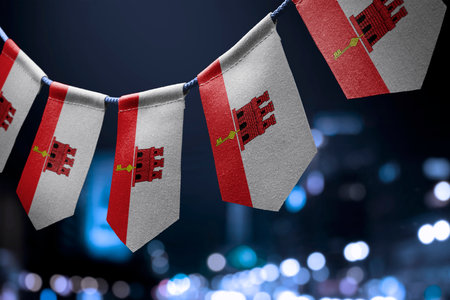 A garland of Gibraltar national flags on an abstract blurred background.の写真素材