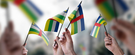 A group of people holding small flags of the Central African Republic in their hands.の写真素材