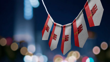 A garland of Gibraltar national flags on an abstract blurred background.の写真素材