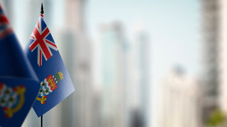 Small flags of the Cayman Islands on an abstract blurry background.の写真素材
