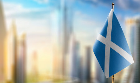 A small Scotland flag on an abstract blurry background.の写真素材