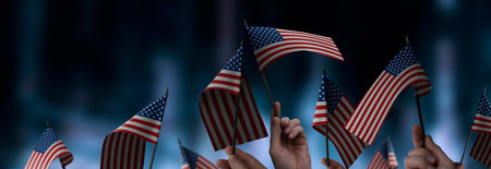 USA flags in their hands on a blurred urban backgroundの写真素材