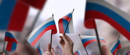 Russia flags in their hands on a blurred urban backgroundの写真素材