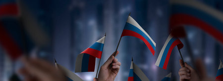 Russia flags in their hands on a blurred urban backgroundの写真素材
