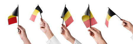 The Belgium flag in hand in different angles on a white backgroundの写真素材