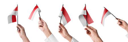 The Indonesia flag in hand in different angles on a white backgroundの写真素材
