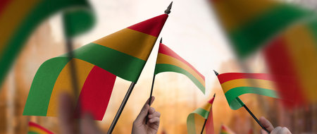Bolivia flags in their hands on a blurred urban backgroundの写真素材