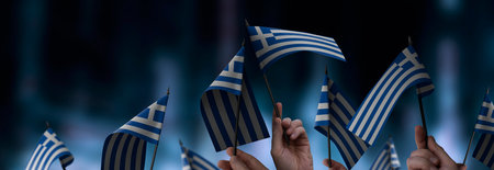 Greece flags in their hands on a blurred urban background