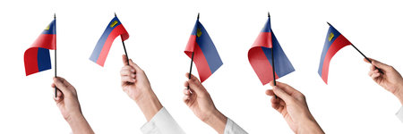The Liechtenstein flag in hand in different angles on a white backgroundの写真素材