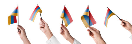 The Armenia flag in hand in different angles on a white backgroundの写真素材