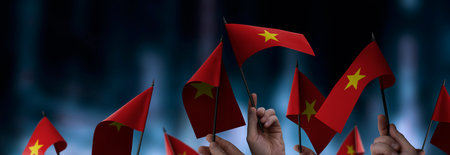 Vietnam flags in their hands on a blurred urban background