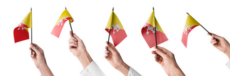 The Bhutan flag in hand in different angles on a white background